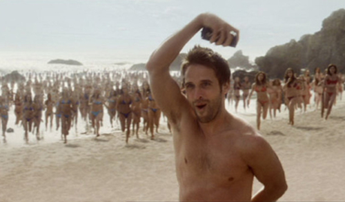 Lynx effect tv advert still. man on beach with women running towards him